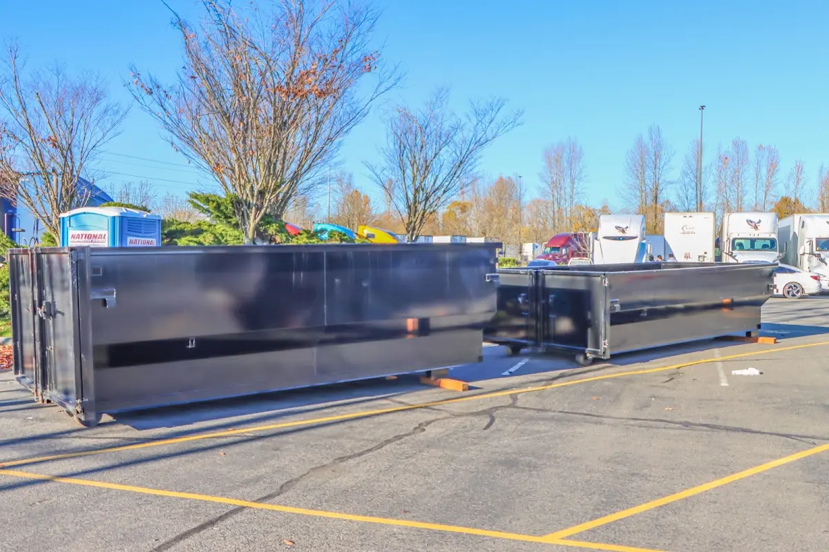 Professional dumpster rental service with roll-off container on residential driveway in Grand Rapids